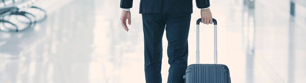 Passenger at the airport carrying a suitcase